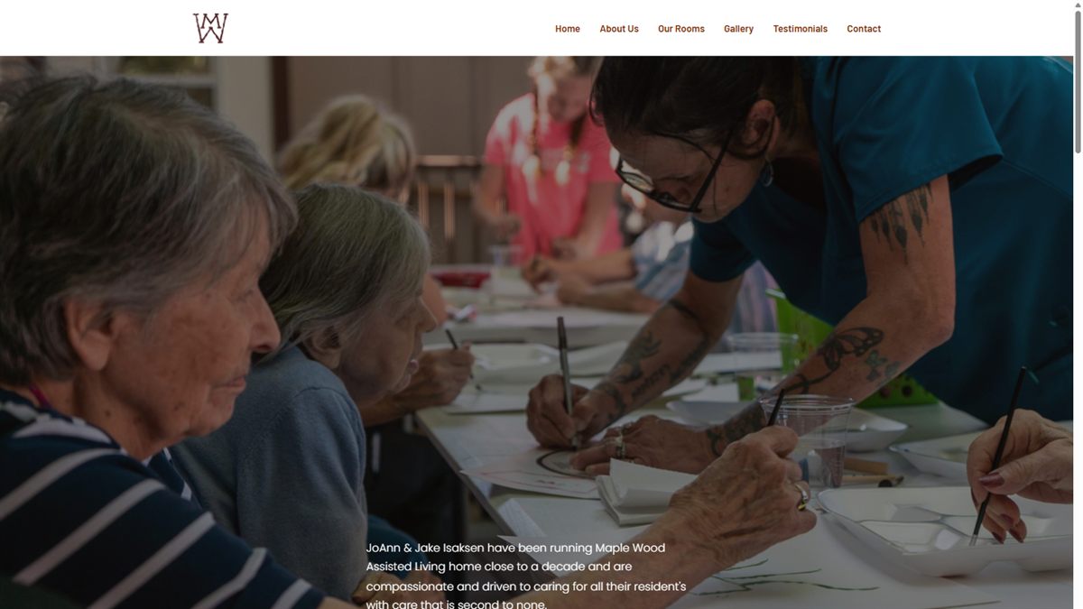 The Maple Wood Assisted Living homepage, showing residents in an activity room.